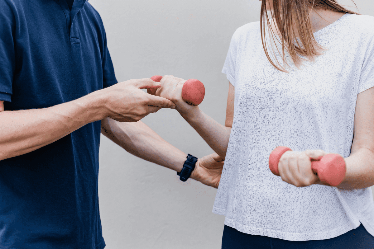 Physiotherapist guiding a patient through rehabilitation exercises